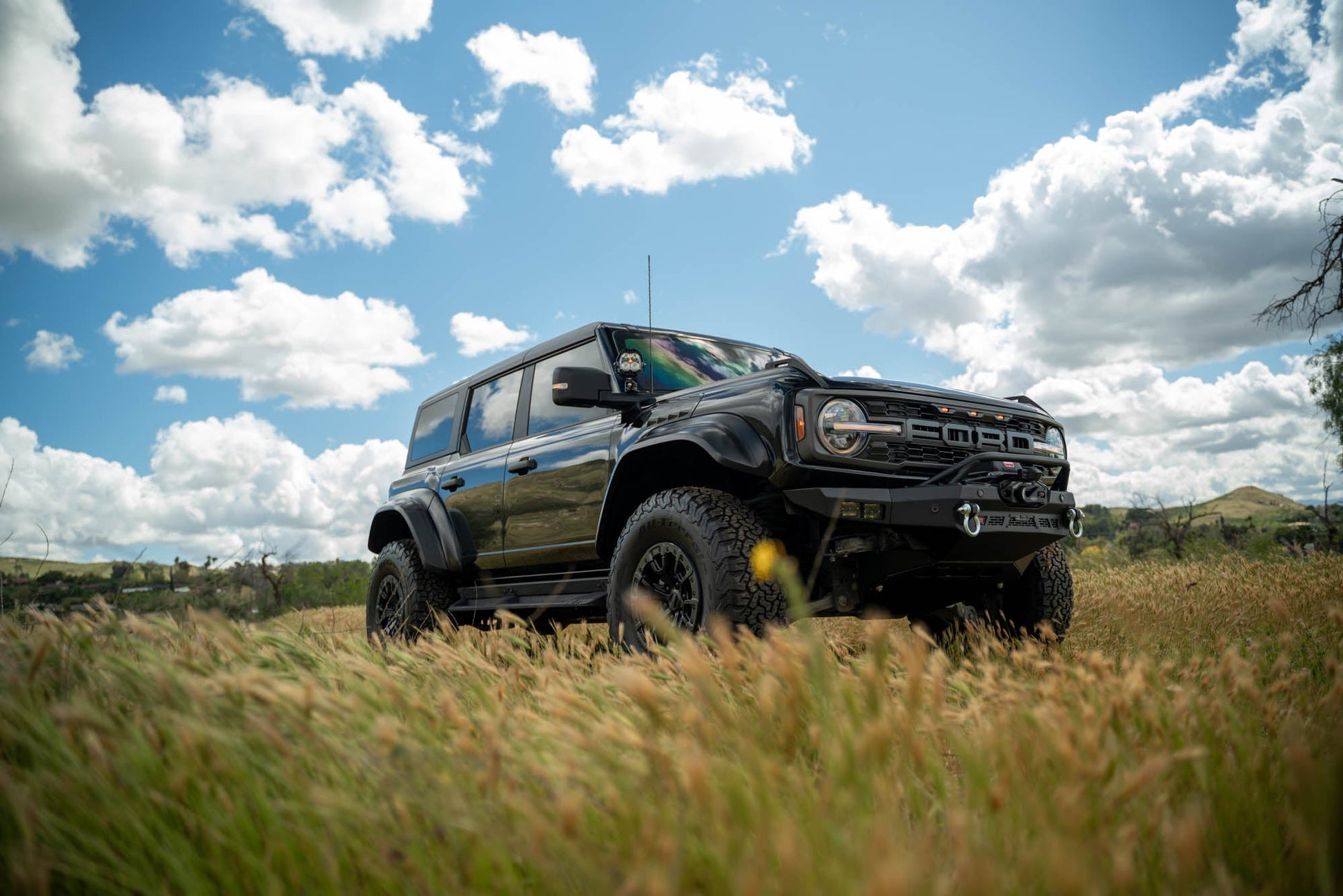 Spec Series Winch Front Bumper for the 2021-2024 Ford Bronco Raptor off road in a field