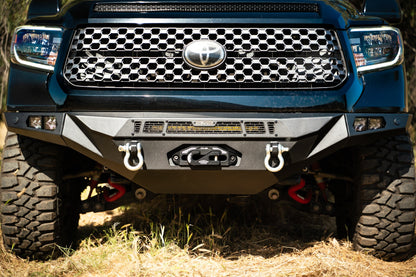 Up close image of spec series Tundra bumper equipped with a 20-inch light bar, two D-rings, and a winch.